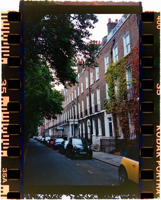 A row of classic houses in London, shot on 35mm film with film borders around the outside of the image