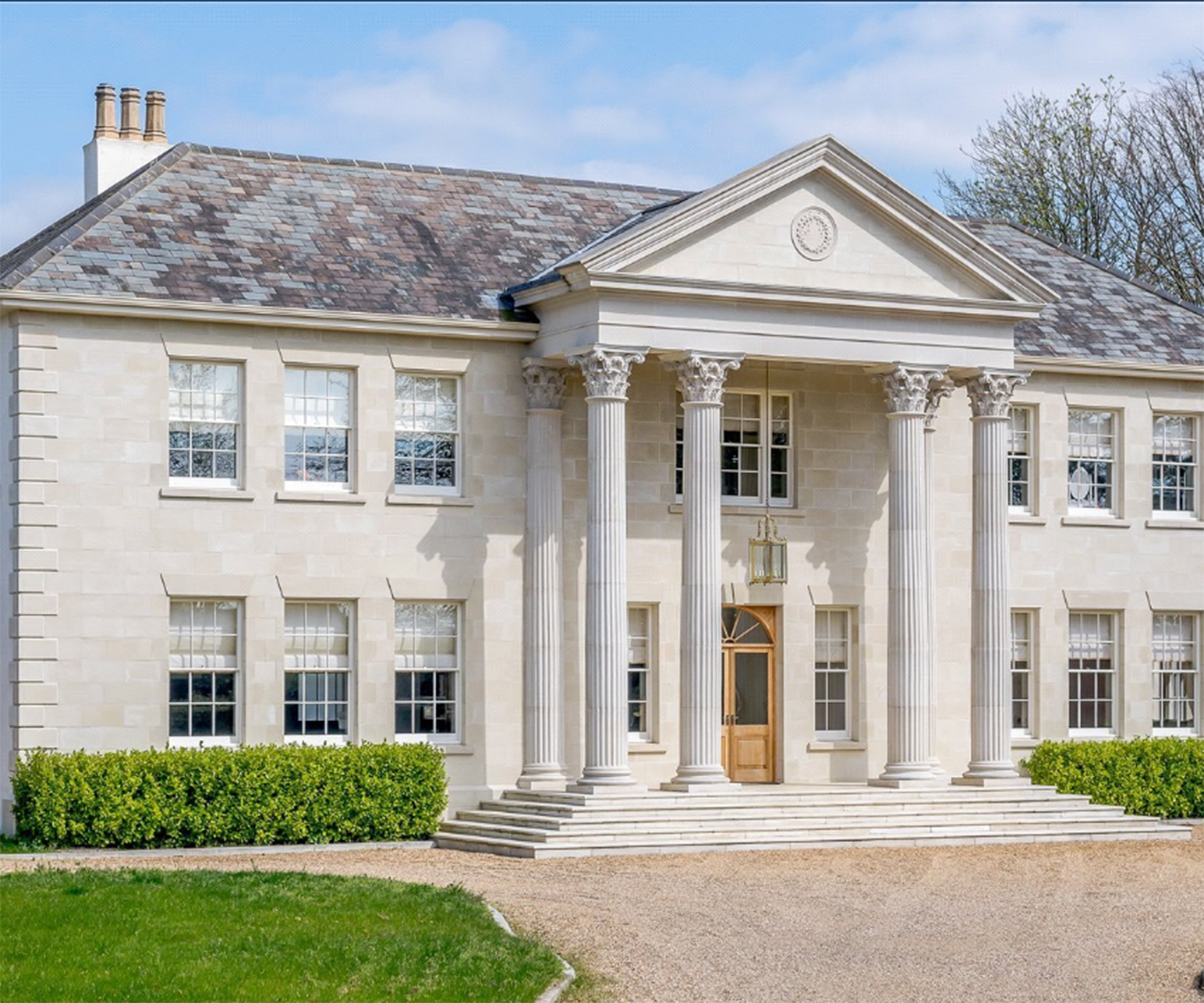 A large white period home with columns
