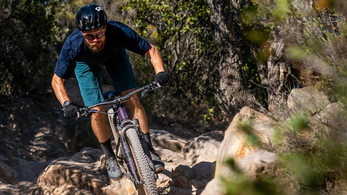 A MTBer rides over some rocks