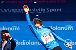 Team UAE's Slovenian rider Tadej Pogacar celebrates his the best climber's blue jersey on the podium of the 6th stage of the 107th Giro d'Italia cycling race, 180 km between Torre del lago Puccini in Viareggio and Rapolano Terme, on May 9, 2024 in Rapolano Terme. (Photo by Luca Bettini / AFP)