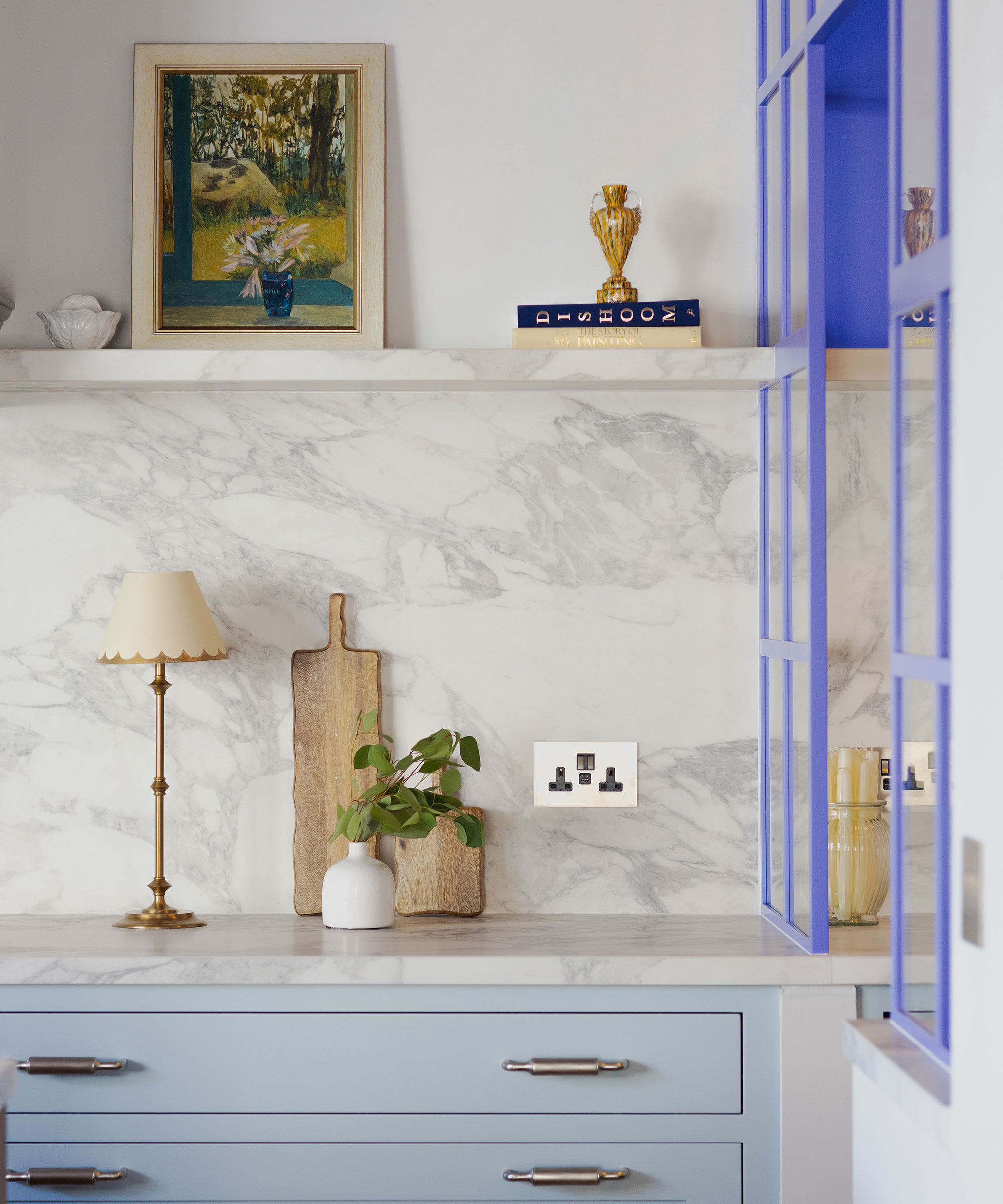 pale blue kitchen with double electrical socket over worktops