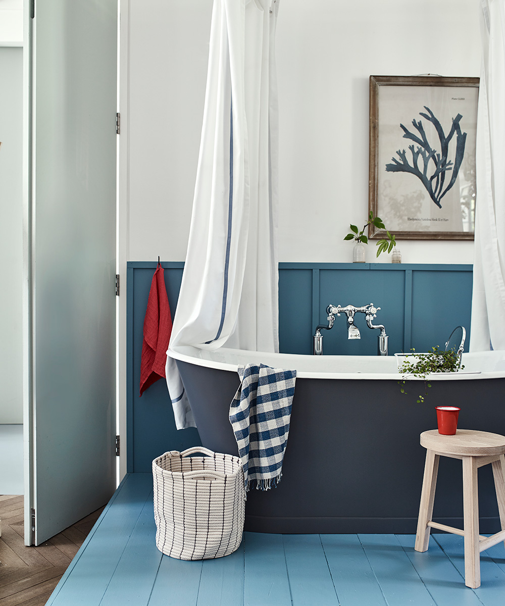 An example of bathroom pictures showing a blue and white nautical themed bathroom with a dark blue freestanding bath