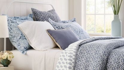 An example of pillow buying rules, a selection of Garnet Hill pillows on a bed.
