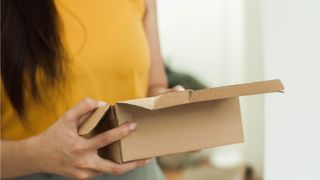 Woman holding cardboard box