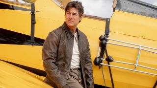 Tom Cruise stands against a yellow biplane in Mission: Impossible - The Final Reckoning.