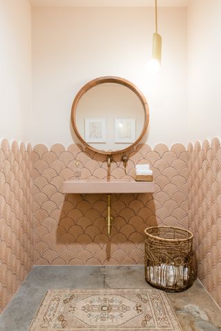 A pink shell-design tiled bathroom