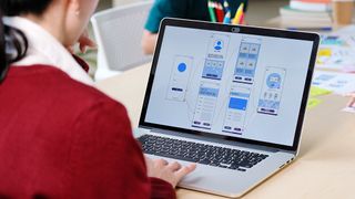 A UI designer uses one of the best UI prototyping tools on a laptop