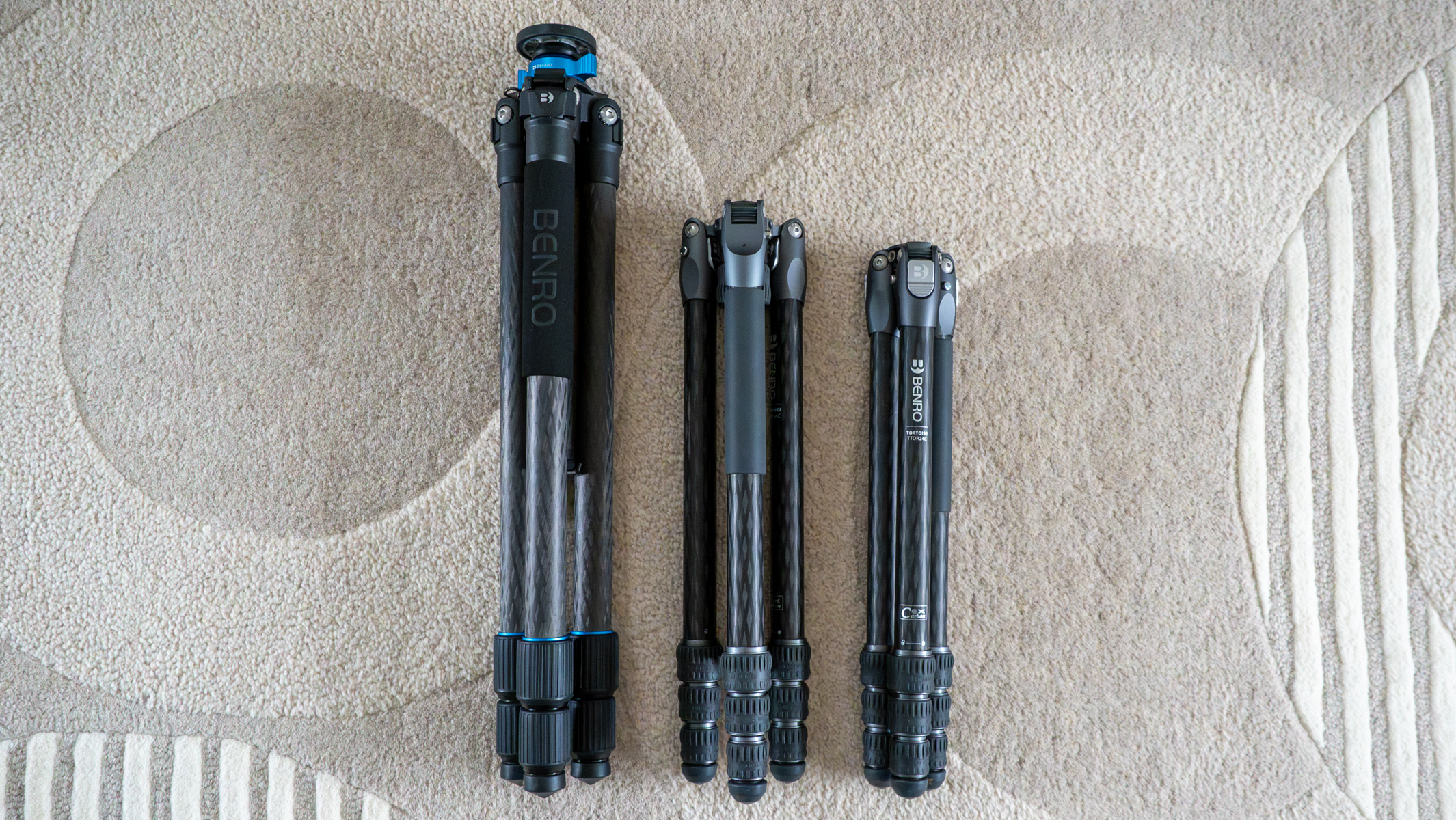 Benro Mach3, Benro Rhino and Benro Tortoise tripods folded on a carpet