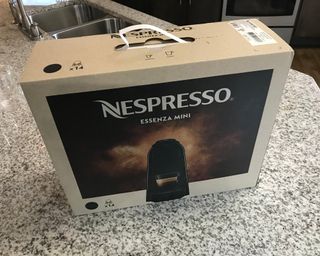 Nespresso Essenza Mini coffee maker packaging with plastic carry handle