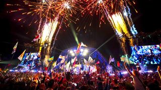 Fireworks explode above the Pyramid Stage at a packed out Glastonbury Festival in 2024.
