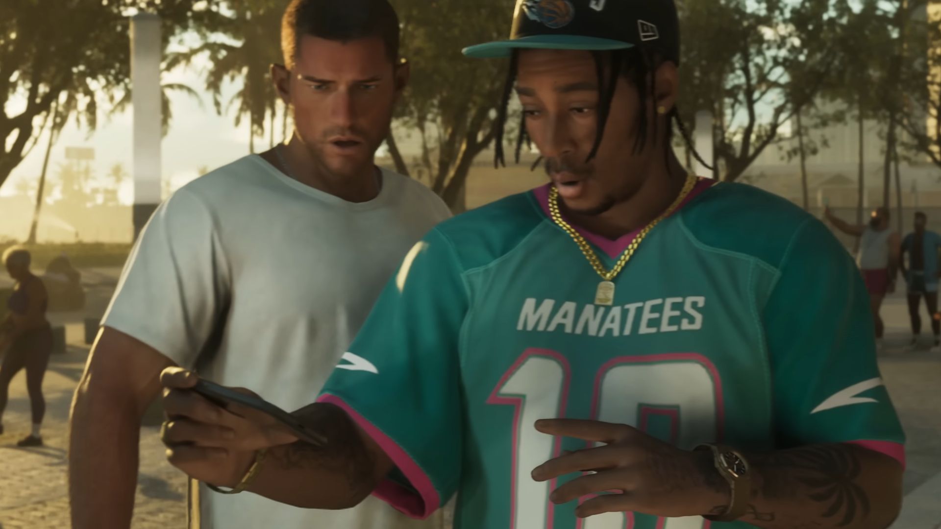 Jason Duval and a friend from Grand Theft Auto 6. They&#039;re standing side by side looking at the man&#039;s phone and seem surprised by what they see. 