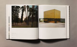 A open book with an image of tall trees on the left page and a gold building on the right page.