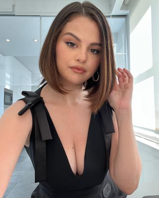 @selenagomez with a sleek, glossy bob hairstyle