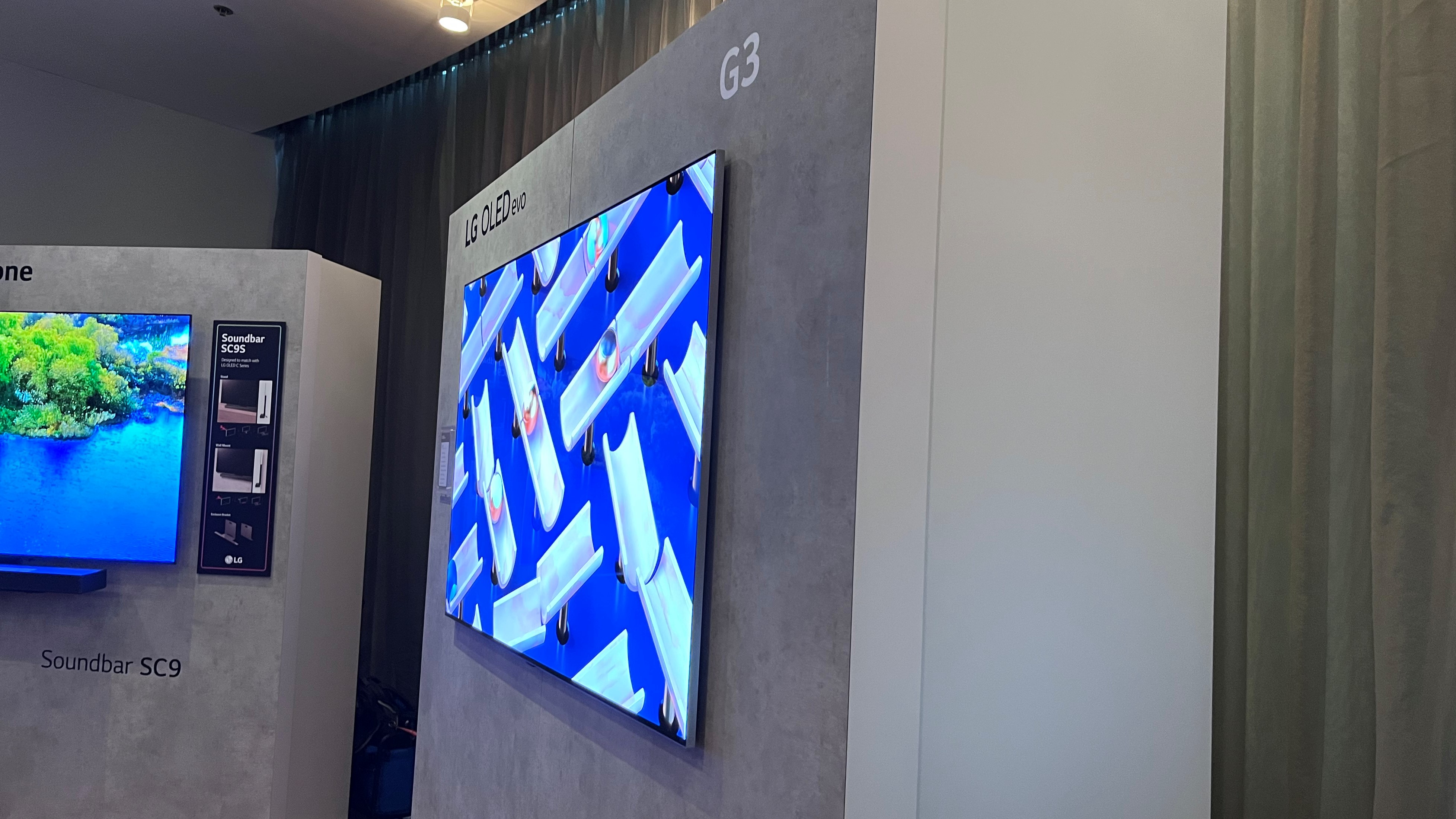 LG G3 OLED TV shown from side mounted to gray wall