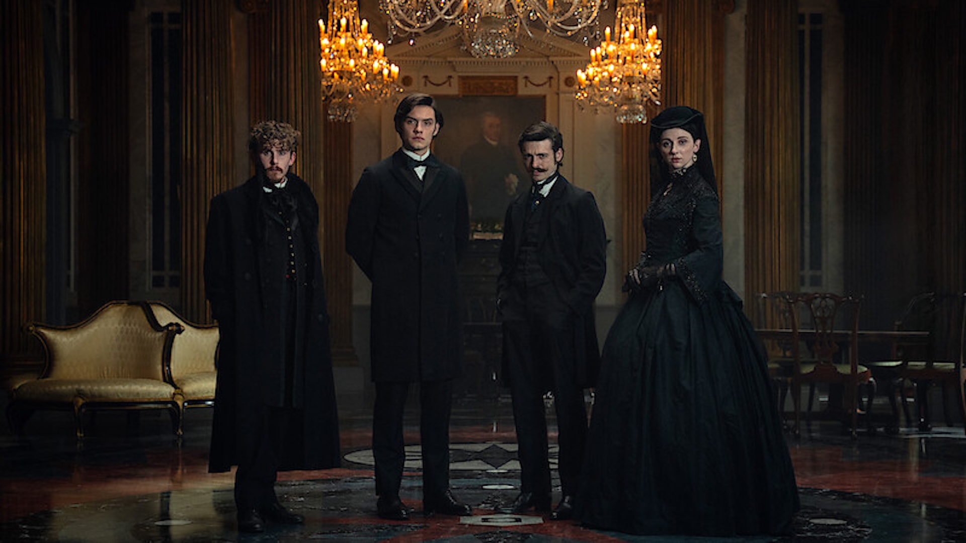 House of Guinness scene - Four people standing in black attire in a house 