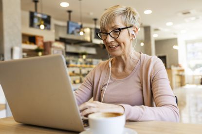 Female working on her laptop wearing headphones