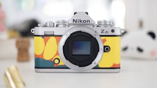 Nikon Z fc Heralbony edition, sat on a white dresser with a mirror and lifestyle accessories