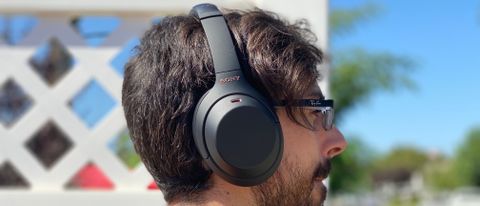 a man wearing the Sony WH-1000XM4 wireless headphones