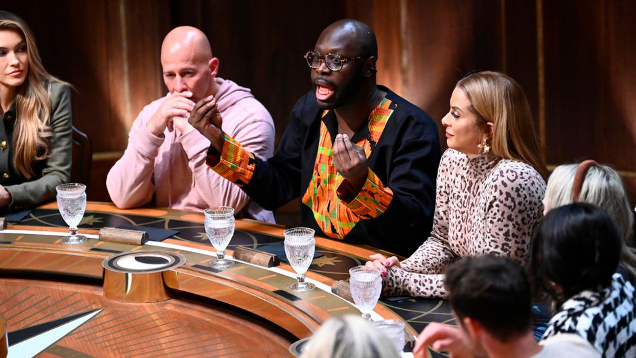 the cast of traitors season 3 sits around the round table while bob the drag queen talks passionately