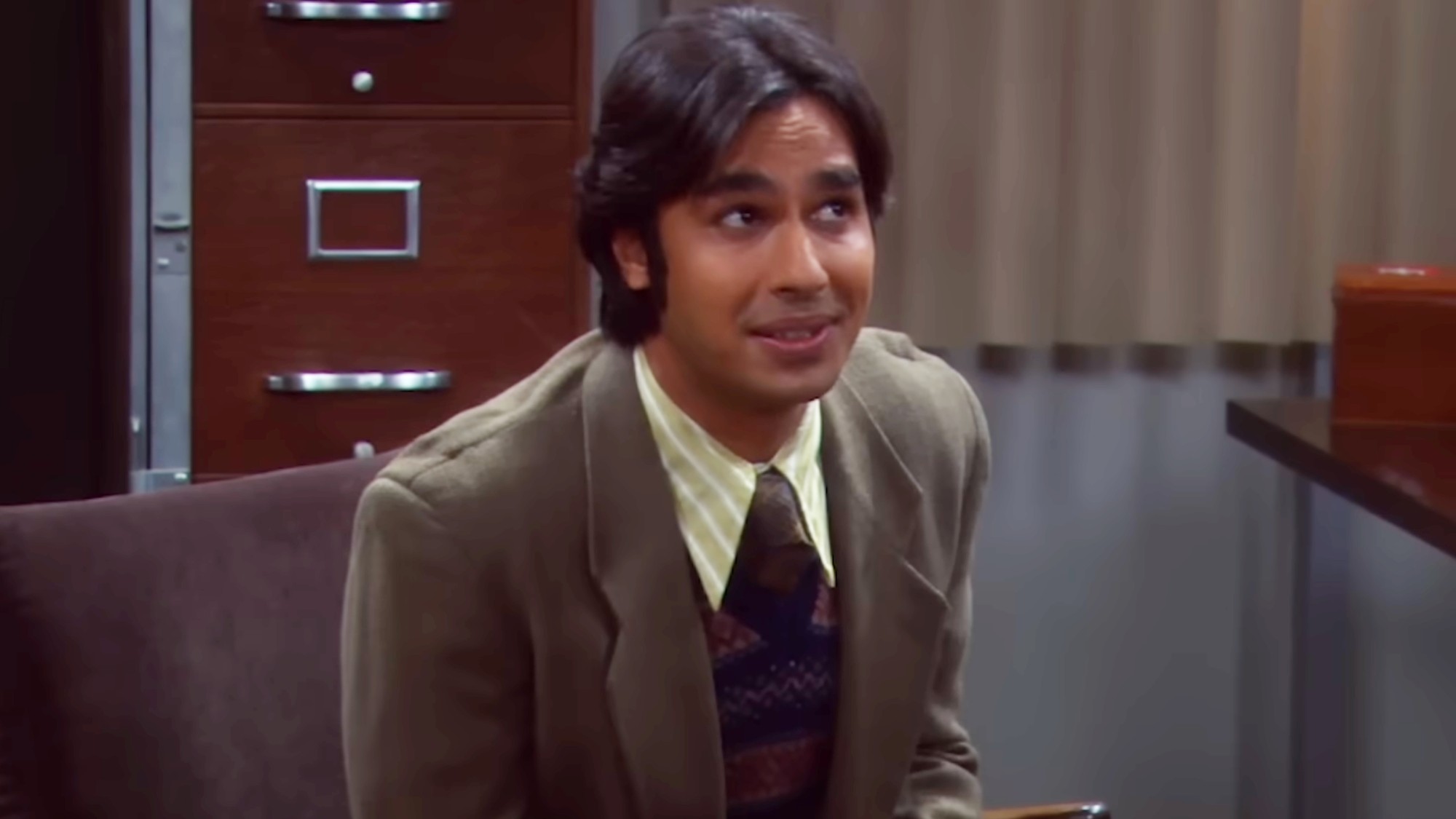 Raj sitting in a chair. 