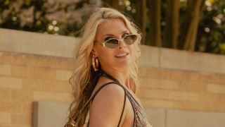 Angela looking back with sunglasses on Landman.