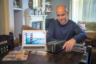 Man scanning 35mm film negatives using a scanner