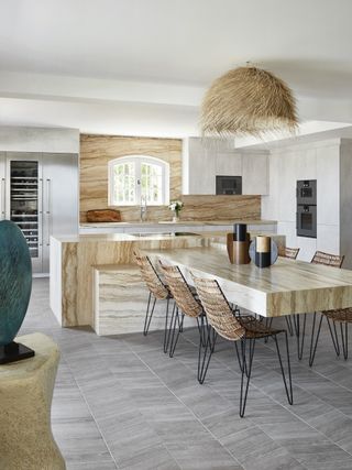 modern country kitchen diner with marbled finishes on countertops and wall