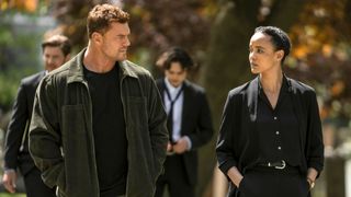 Neagley and Reacher walk and talk at a funeral