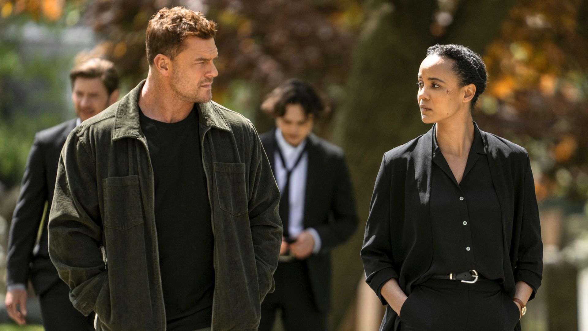 Neagley and Reacher walk and talk at a funeral