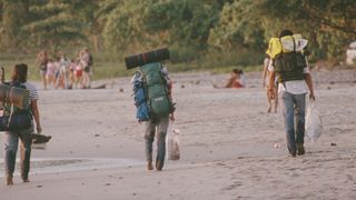 Three backpackers on the beach in Costa Rica