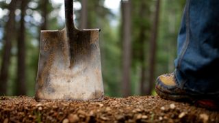 Trail builder's spade on an MTB trail