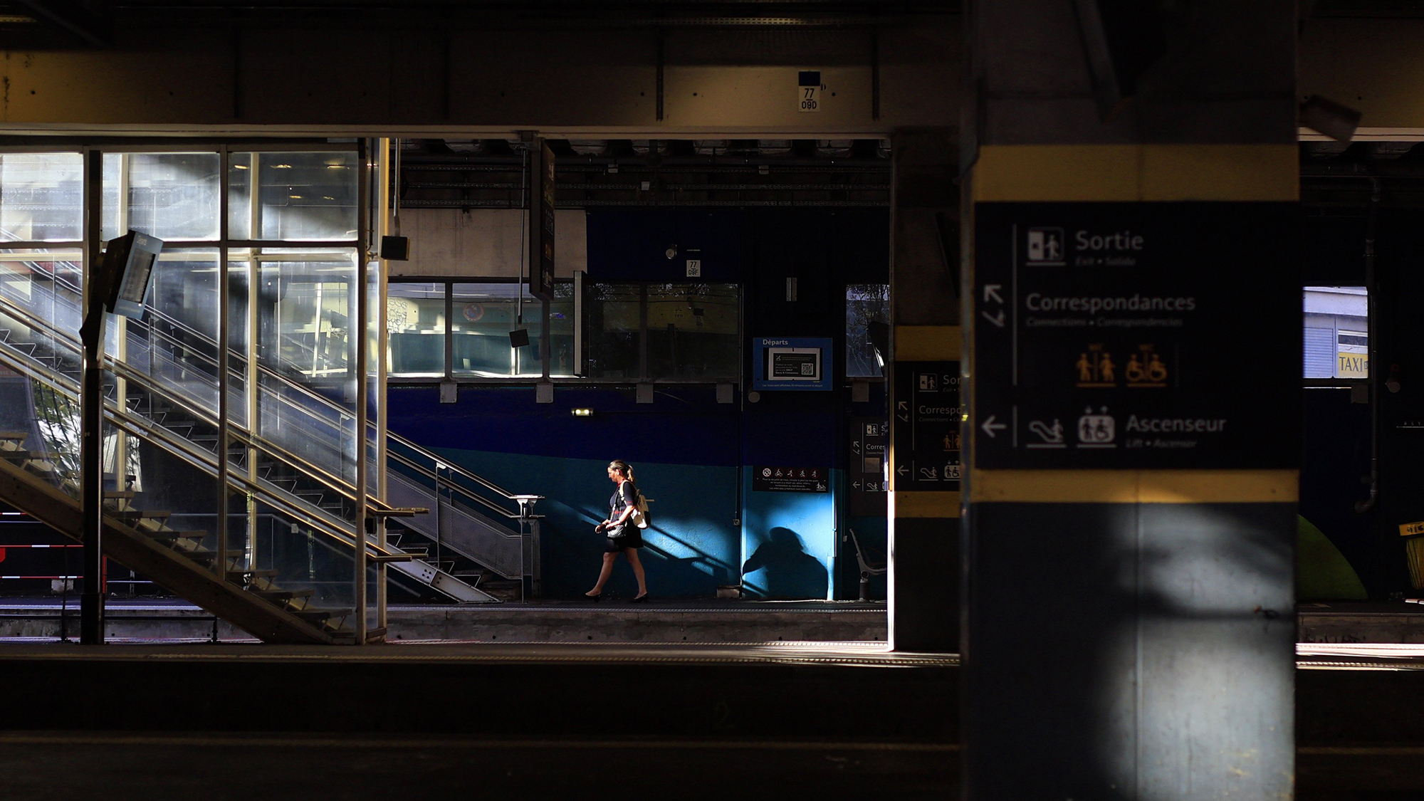 A woman walks along an empty platform at Montpellier-Saint-Roch train station during an SNCF strike in Montpellier, southern France