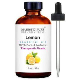 A brown bottle of lemon essential oil with a white label and pipette