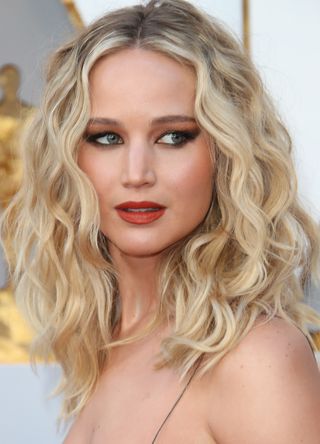 Jennifer Lawrence with dramatic winged eyes and bold lips