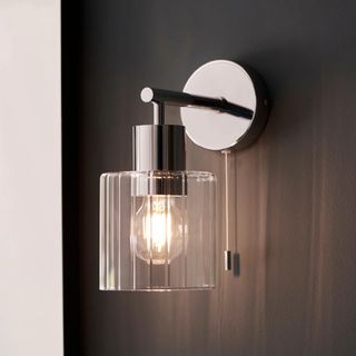 glass ribbed shaded wall light wth chrome base and light pull