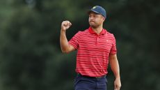 Xander Schauffele fist pumps after holing a putt at the 2022 Presidents Cup