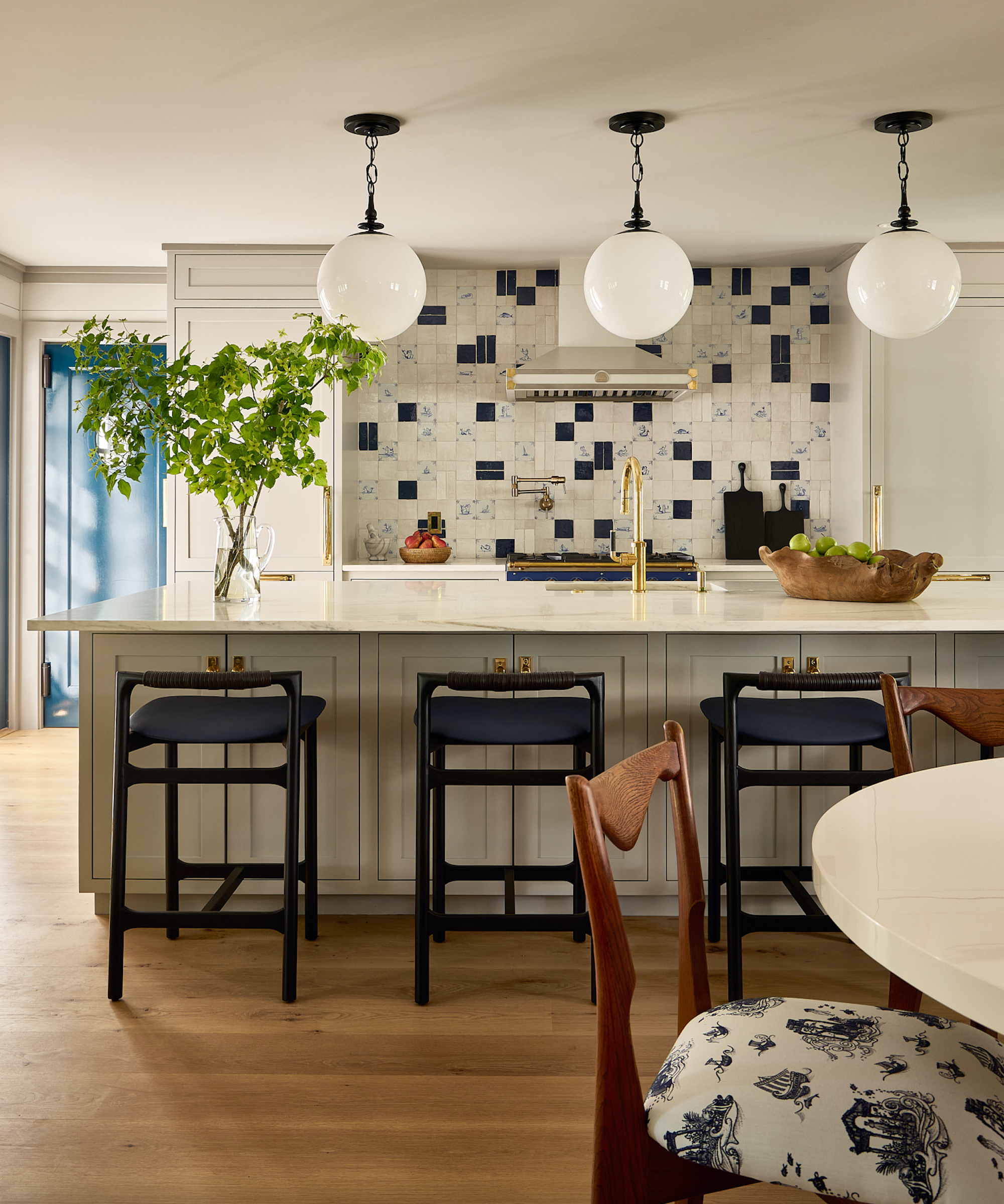 off-white kitchen with island and wood flooring