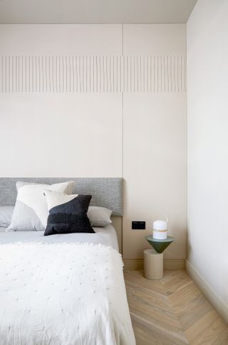 White bedroom with grey upholstered headboard