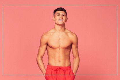 A Love Island press shot of Haris Namani wearing swimming trunks against a pink background