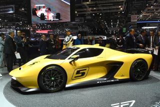 People gather next to the Emerson Fittipaldi EF7on the first press day of the the Geneva International Motor Show on March 7, 2017 in Geneva. Europe's biggest annual car show kicks off in Gen