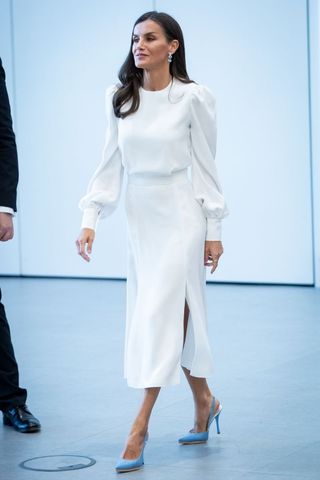 Queen Letizia wearing a white midi dress and blue heels