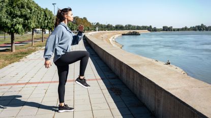 A woman performing the high knees exercise