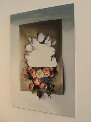 Poster of a floral arrangement. The top half has been cut around and flipped upside down