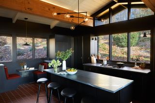 A kitchen with island seating and window seating