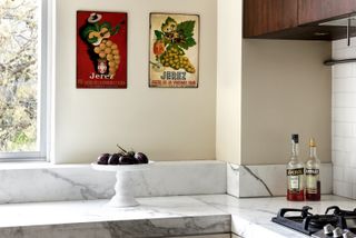 A kitchen with food paintings