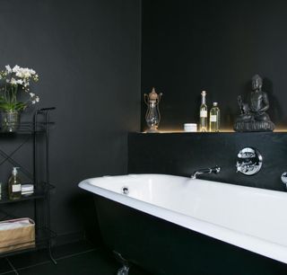 bathroom with black wall and white bathtub