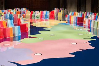Gaetano Pesce’s set for Bottega Veneta with bright, colourful chairs along a colourful runway