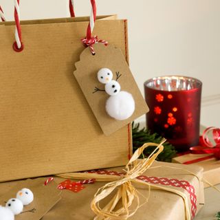 Brown paper Christmas gift bag with a snowman tag