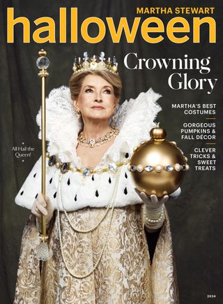 Martha Stewart wearing a ruffled white head dress and crown holding a sceptor and orb