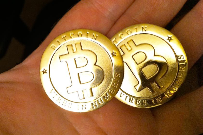 Two Bitcoins in a person&amp;#039;s hands